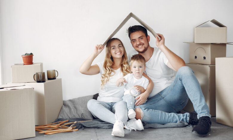 Family moving. People use a boxes. Little boy with parents.